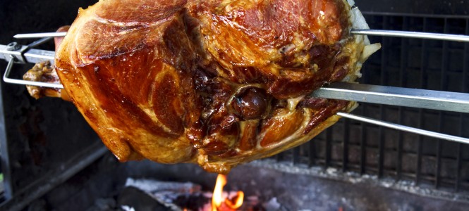 Tuscan-Style Roast Pork – Harvest Grilling Series Smoked pork haunch on spit over wood fire.