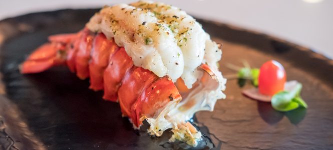 Valentine’s Day Grilled Lobster Tails Grilled Lobster and vegetables on plate.